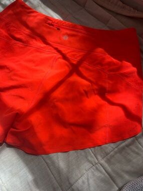Athleta orange speed-up shorts